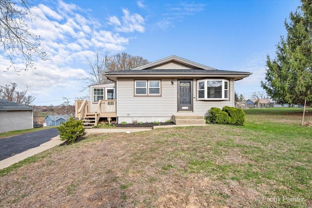 bungalow-style home featuring a front yard
