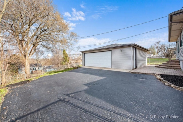 detached garage featuring fence