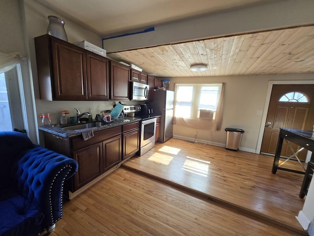 5750 W 65th St, Chicago, IL 60638 - kitchen with dark brown cabinetry, baseboards, light wood-style flooring, appliances with stainless steel finishes, and a sink