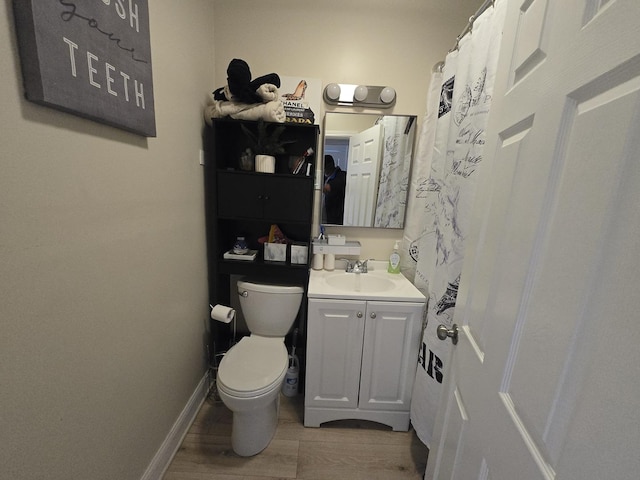 5750 W 65th St, Chicago, IL 60638 - full bath with vanity, baseboards, toilet, and wood finished floors