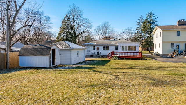 4933 Woodward Ave, Downers Grove, IL 60515 - back of property featuring an outbuilding, a wooden deck, a yard, a storage unit, and fence