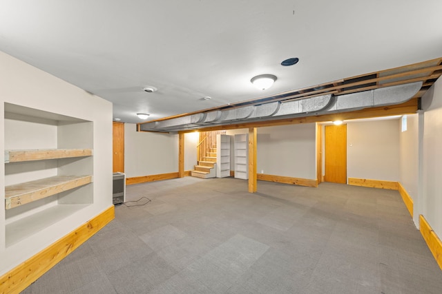 finished below grade area with baseboards and stairway