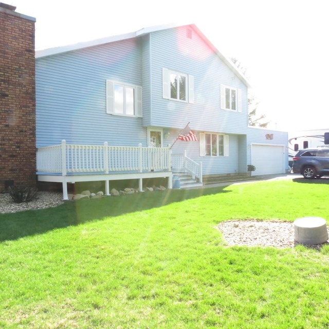 10902 E French St, Grant Park, IL 60940 - back of house with a deck, a garage, and a lawn