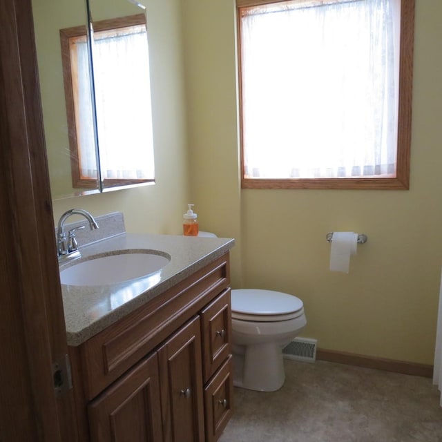 10902 E French St, Grant Park, IL 60940 - half bathroom with vanity, baseboards, visible vents, and toilet
