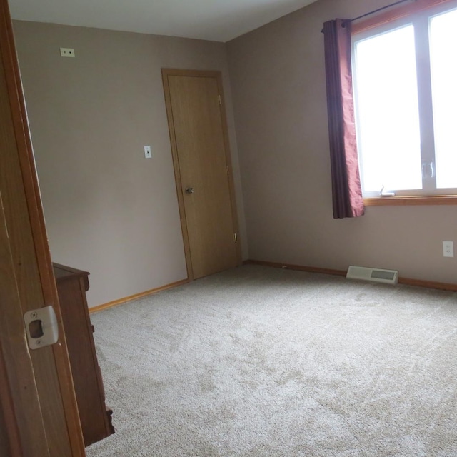 10902 E French St, Grant Park, IL 60940 - empty room with baseboards, visible vents, and carpet floors