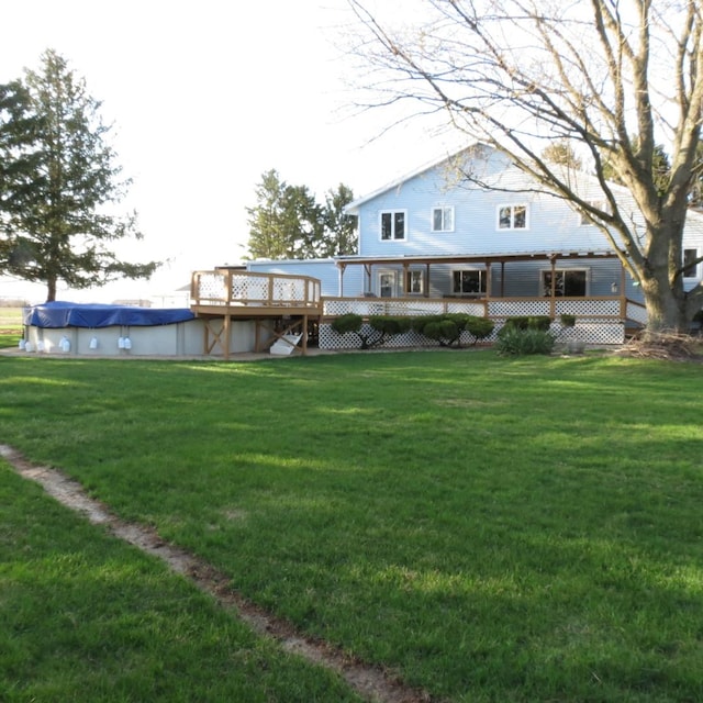 10902 E French St, Grant Park, IL 60940 - back of house with a deck, a covered pool, and a lawn