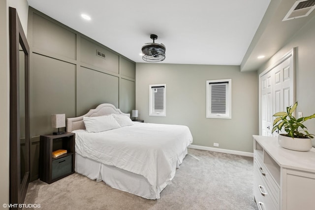 bedroom with light carpet, visible vents, and recessed lighting