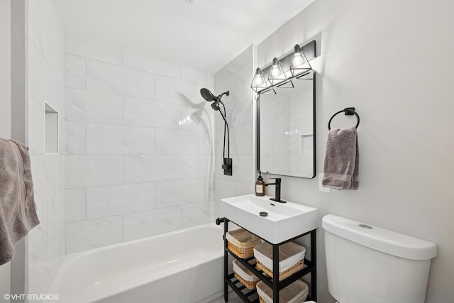 bathroom featuring a sink, toilet, and shower / bath combination