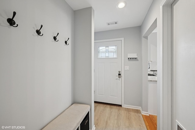 mudroom featuring light wood finished floors and visible vents