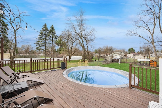 view of swimming pool featuring a fenced backyard, a wooden deck, and a lawn