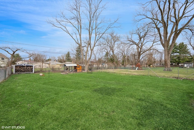 view of yard with a fenced backyard and an outdoor structure