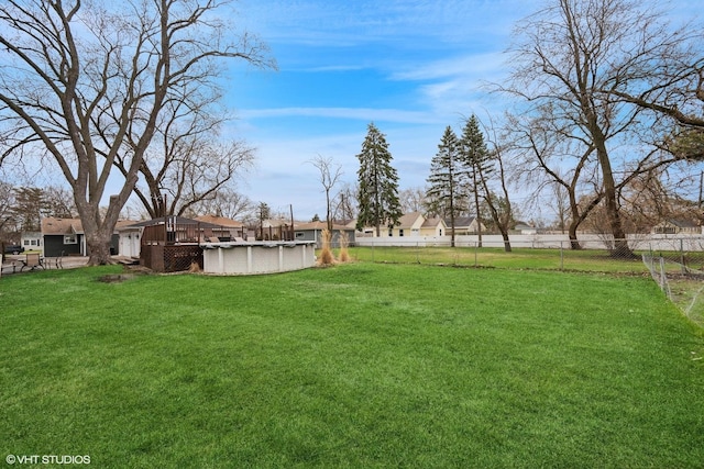 view of yard with fence and a fenced in pool