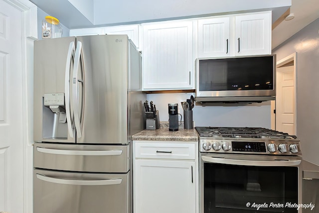 kitchen with white cabinets, light countertops, and appliances with stainless steel finishes