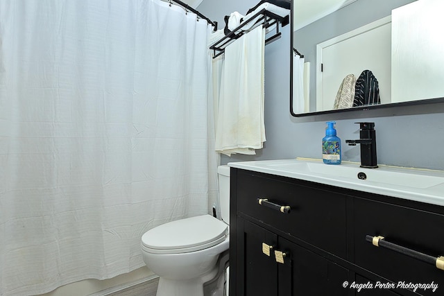 bathroom featuring toilet and vanity