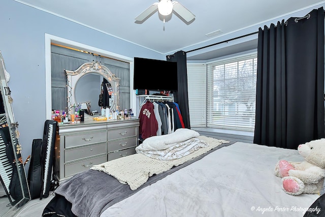 bedroom featuring visible vents, crown molding, and ceiling fan