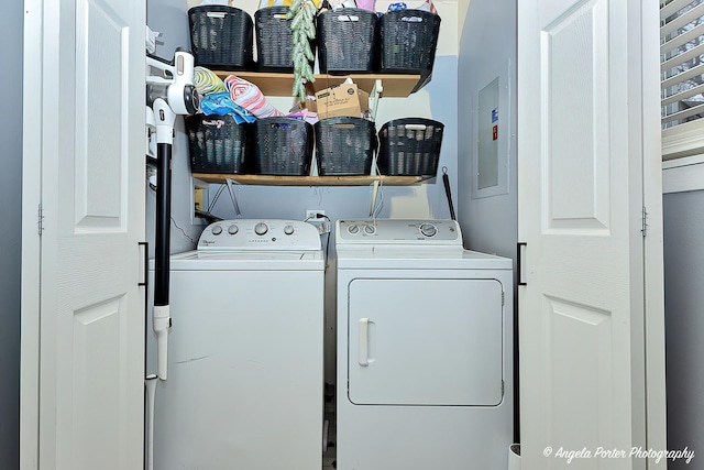 laundry area featuring electric panel, washer and dryer, and laundry area