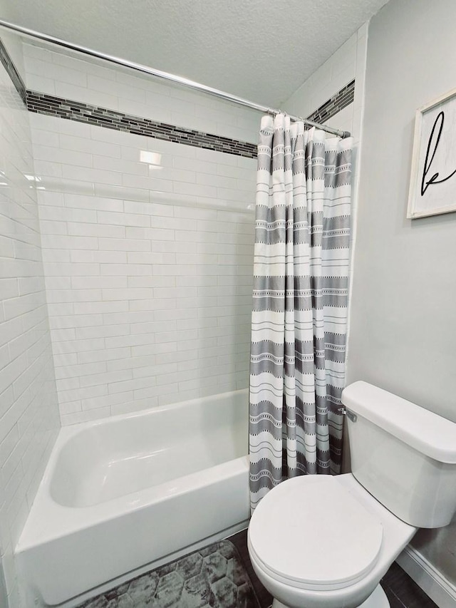 bathroom featuring shower / bathtub combination with curtain, a textured ceiling, and toilet