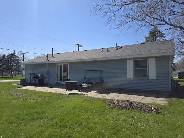 back of house with a patio area, a shingled roof, and a lawn