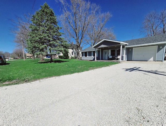 ranch-style house with a garage, a front yard, driveway, and covered porch