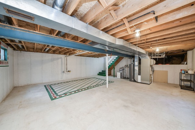 unfinished basement with stairs, water heater, visible vents, and heating unit