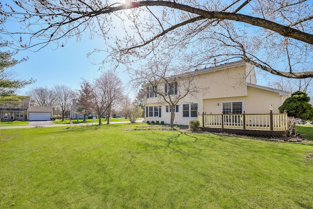 view of yard with a wooden deck and a detached garage