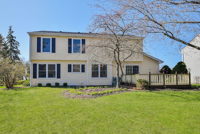 back of property featuring a yard and a deck