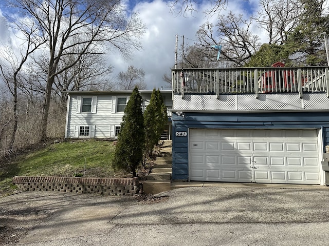 view of front of home with an attached garage and aphalt driveway