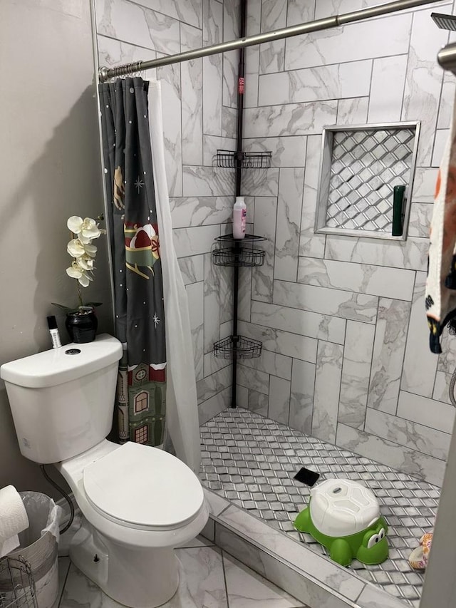 full bath featuring toilet, a stall shower, and marble finish floor
