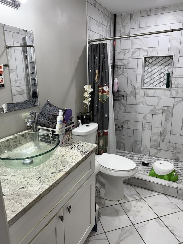 full bathroom featuring a shower stall, marble finish floor, vanity, and toilet