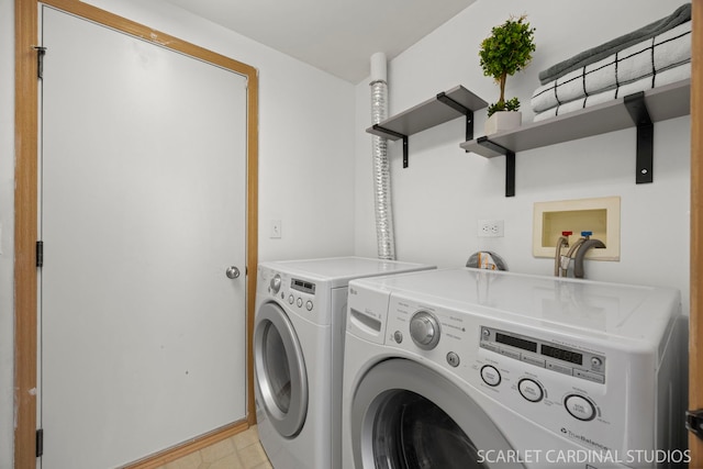 washroom with baseboards, independent washer and dryer, and laundry area