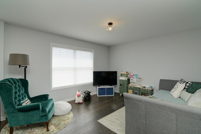 living area with baseboards and dark wood finished floors