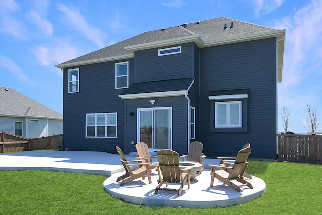 rear view of property with a patio area, fence, a fire pit, and a lawn