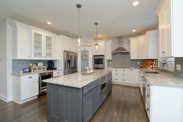 kitchen featuring a sink, wall chimney range hood, wine cooler, stainless steel appliances, and gray cabinets