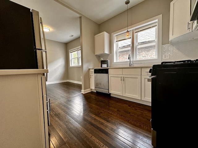 1824 W 22nd Pl, Chicago, IL 60608 - kitchen with stainless steel appliances, dark wood-style floors, white cabinets, decorative light fixtures, and light countertops