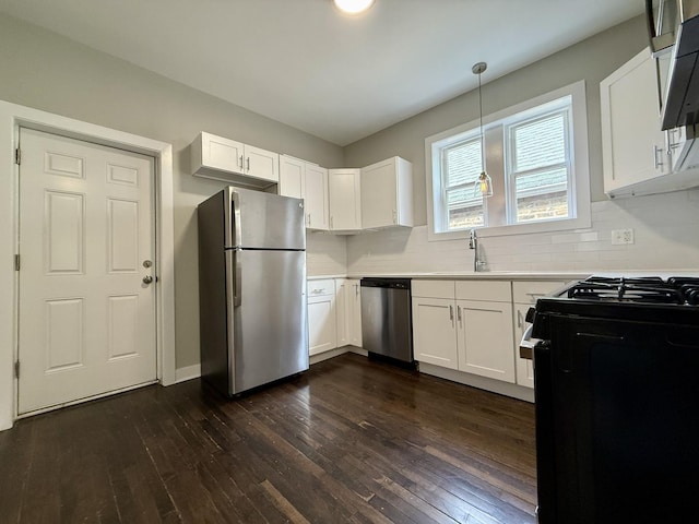 1824 W 22nd Pl, Chicago, IL 60608 - kitchen with stainless steel appliances, light countertops, dark wood-style floors, and white cabinets