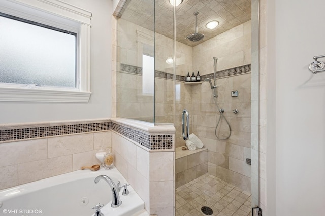 full bath featuring a shower stall and a tub with jets