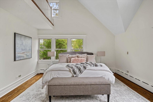 820 Lake Ave, Wilmette, IL 60091 - bedroom with baseboard heating, multiple windows, wood finished floors, and vaulted ceiling