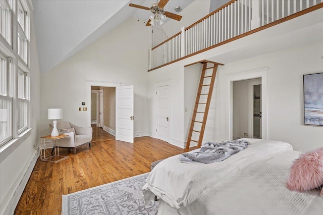 820 Lake Ave, Wilmette, IL 60091 - bedroom featuring high vaulted ceiling, wood finished floors, a baseboard heating unit, baseboards, and ceiling fan