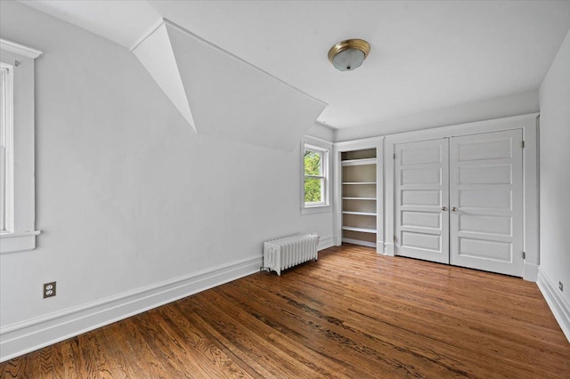 820 Lake Ave, Wilmette, IL 60091 - unfurnished bedroom featuring radiator heating unit, wood finished floors, baseboards, and lofted ceiling