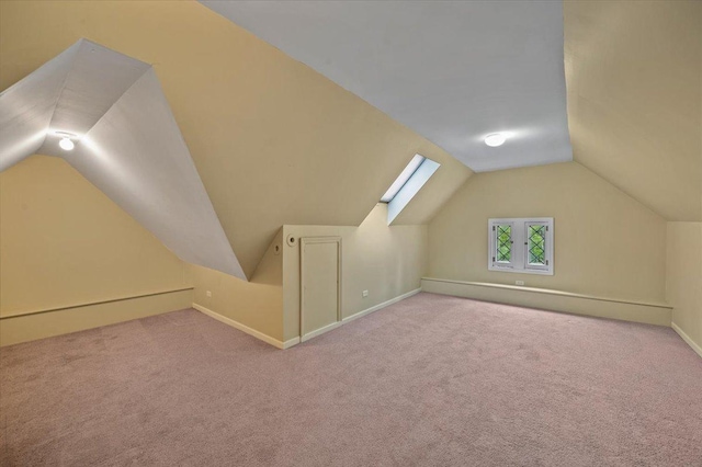 820 Lake Ave, Wilmette, IL 60091 - additional living space featuring vaulted ceiling, carpet flooring, and baseboards