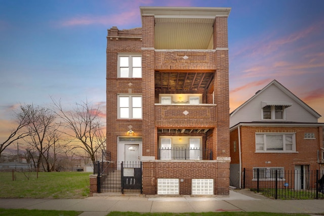 1234 S Karlov Ave, Chicago, IL 60623 - townhome / multi-family property featuring brick siding, a garage, a fenced front yard, and a balcony