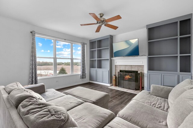 1904 Heron View Way, Round Lake, IL 60073 - living area with a tiled fireplace, wood finished floors, a ceiling fan, baseboards, and built in features