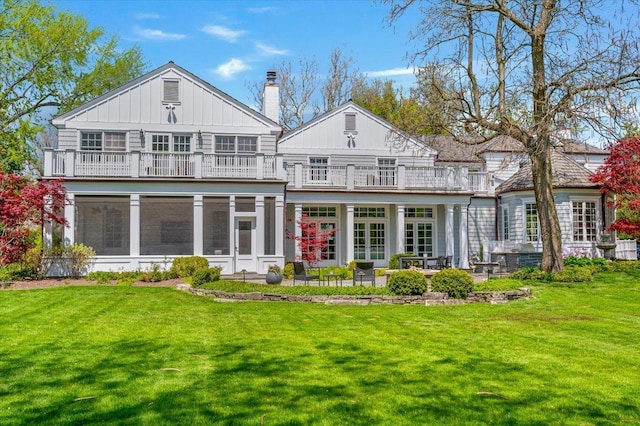 280 Old Farm Rd, Northfield, IL 60093 - rear view of property featuring a balcony, a patio area, a chimney, a yard, and board and batten siding