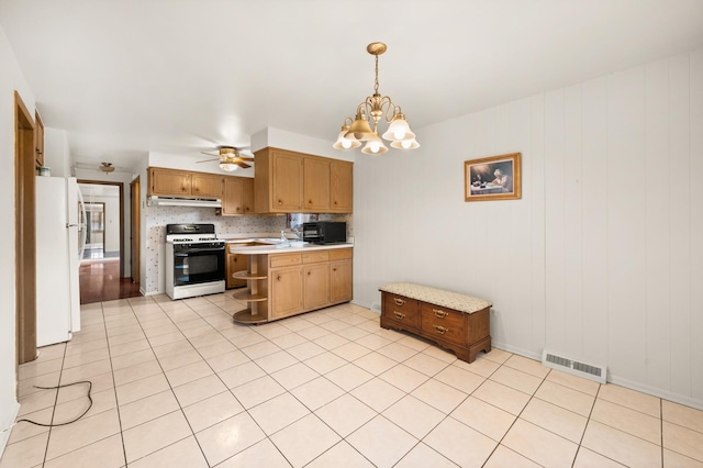 31 W 126th Pl, Chicago, IL 60628 - kitchen with black microwave, light countertops, freestanding refrigerator, visible vents, and range with gas cooktop