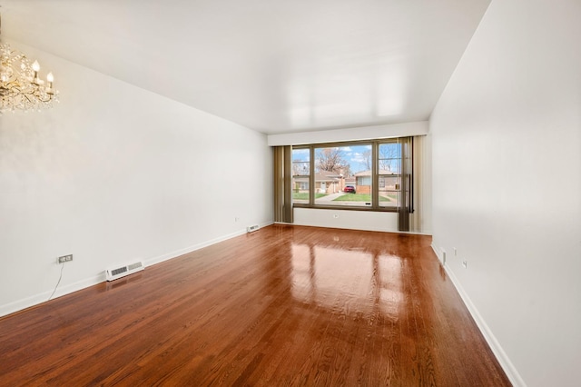 31 W 126th Pl, Chicago, IL 60628 - spare room featuring a notable chandelier, visible vents, baseboards, and wood finished floors