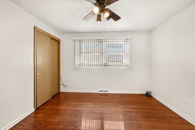 31 W 126th Pl, Chicago, IL 60628 - empty room with visible vents, a textured ceiling, a ceiling fan, and wood finished floors