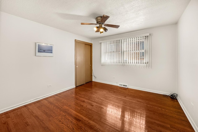 31 W 126th Pl, Chicago, IL 60628 - unfurnished room featuring ceiling fan, a textured ceiling, visible vents, wood finished floors, and baseboards
