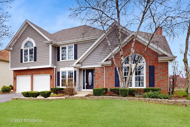 view of front facade featuring aphalt driveway, a front yard, brick siding, a chimney, and a garage