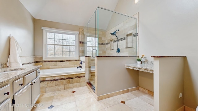 full bathroom with vanity, vaulted ceiling, tile patterned flooring, a shower stall, and a garden tub