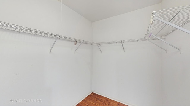 spacious closet with wood finished floors